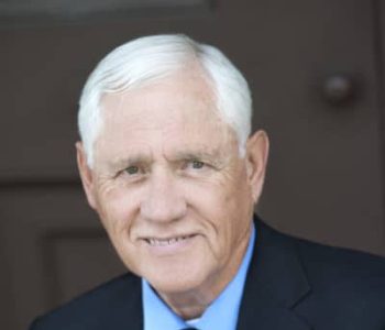 A Man Wearing A Suit And Tie