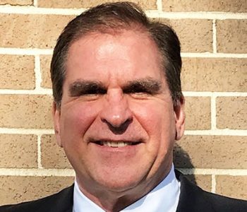 A Man Wearing A Suit And Tie