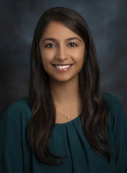 a woman who is smiling and looking at the camera