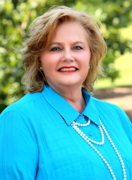 a girl in a blue shirt and smiling at the camera PATTI-ROSENOW