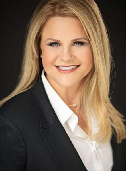 a woman wearing a suit and tie smiling at the camera BETH-PIPPIN