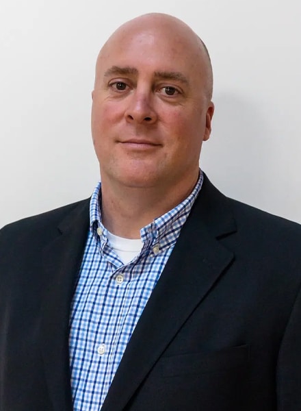 a man wearing a suit and tie smiling at the camera. JAY-HORNBUCKLE