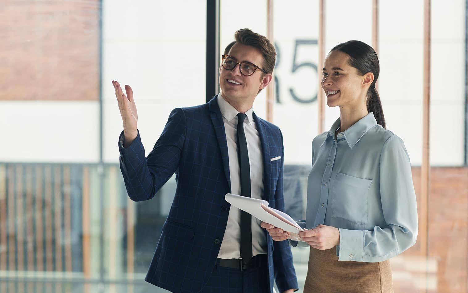 a person in a suit standing in front of a building