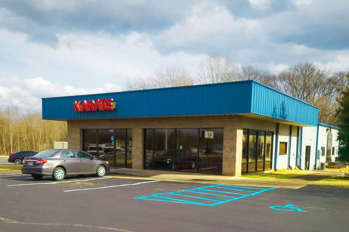A Building With A Sign That Says 'Karate' Owned By CMA Management, LLC And Represented By NAI Chase Commercial