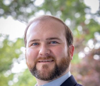 A Man Wearing A Suit And Tie