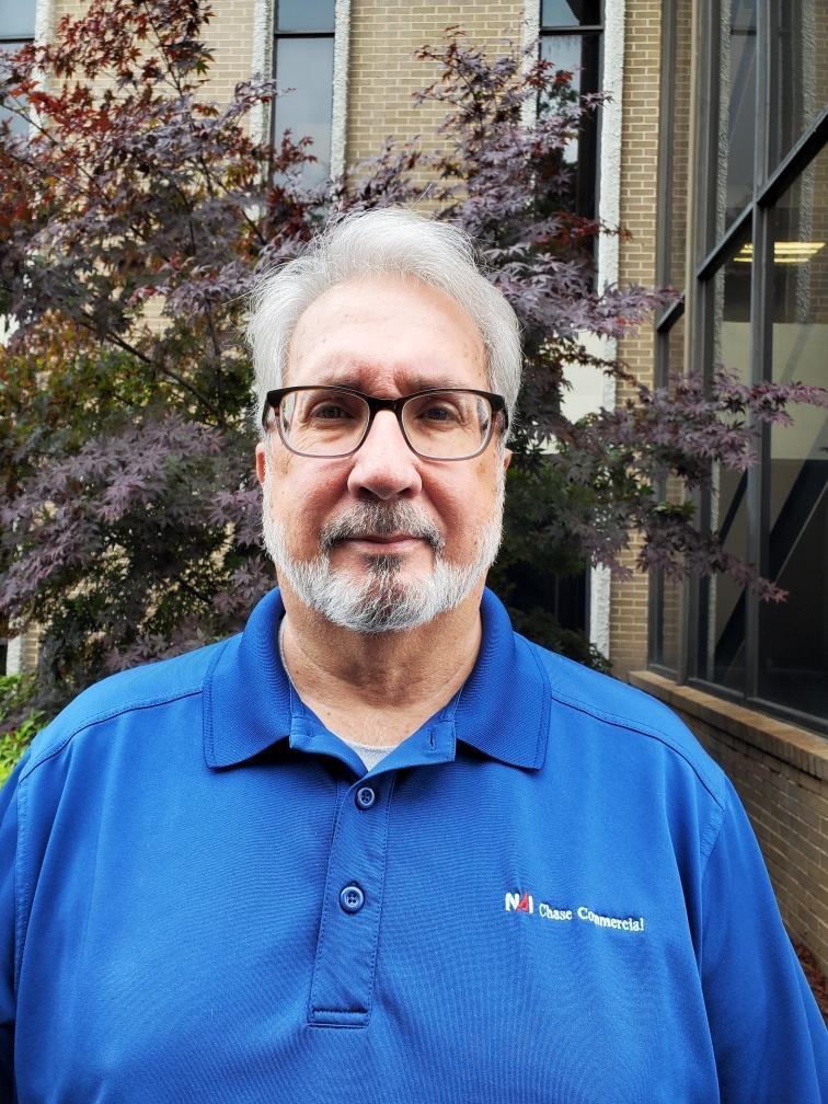 a man wearing glasses and a blue shirt