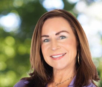 A Woman Smiling For The Camera