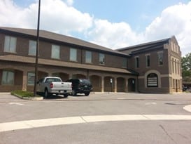 An Empty Parking Lot In Front Of A Building